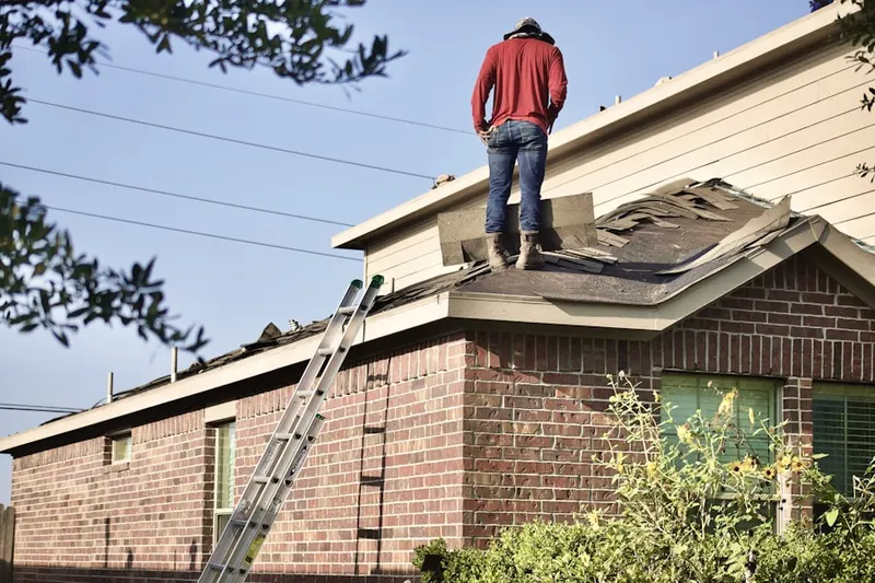 Professional roofer working on a residential roof in Basin City